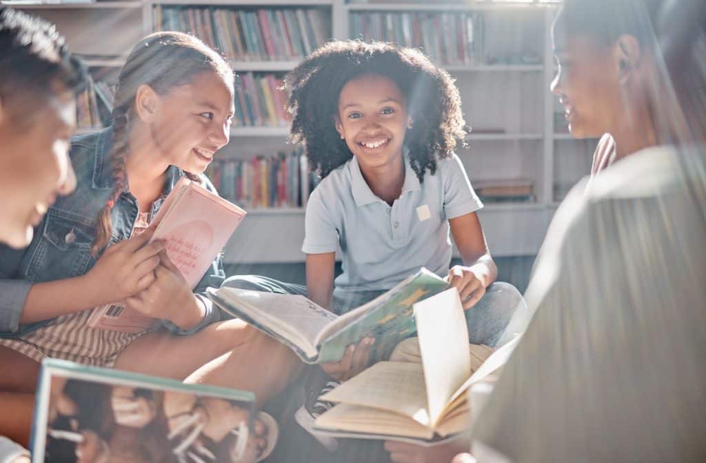 Group of tweens read while sitting in a circle.